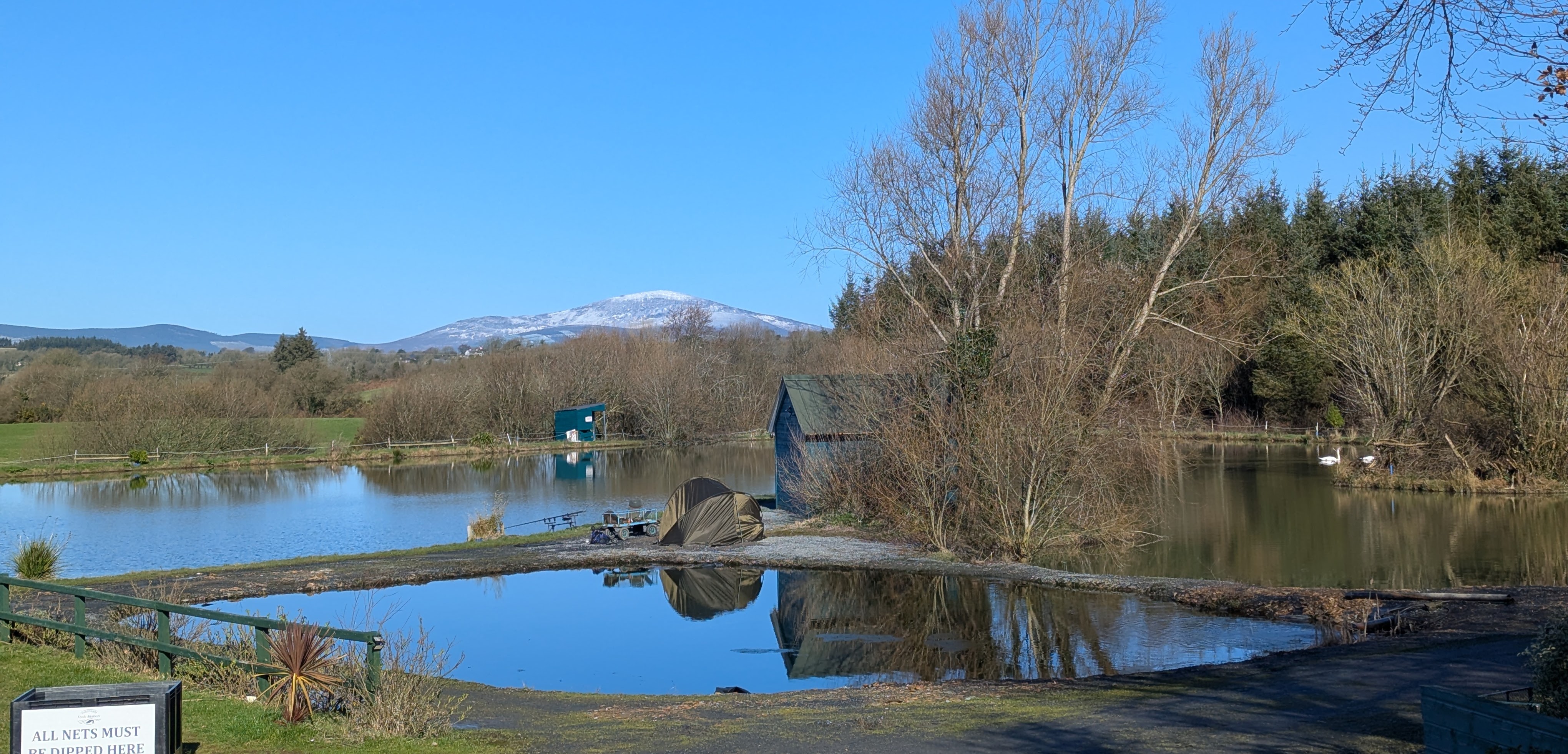 Scenic view of Loch Mahon fishing lake — the perfect setting for fishing lessons